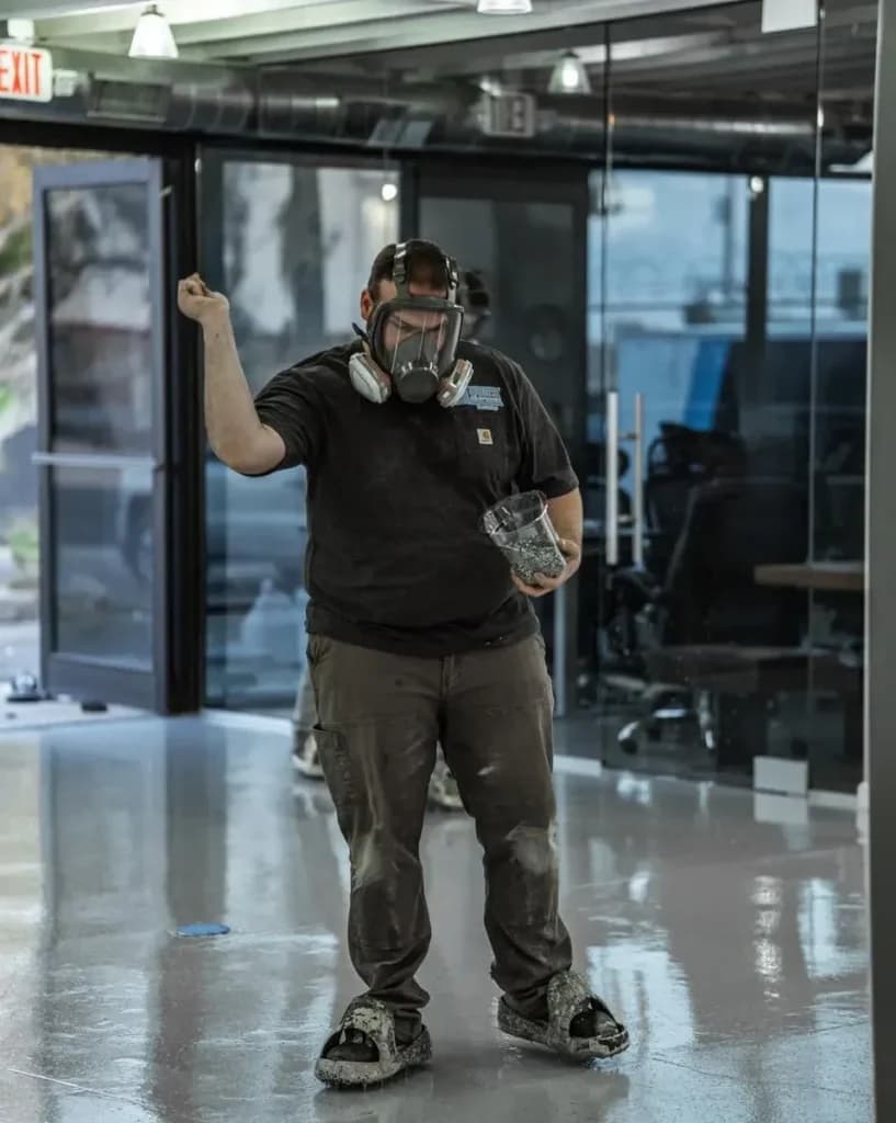 Professional installer broadcasting decorative flakes during an epoxy floor coating